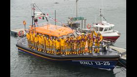 Leverburgh Lifeboat tied alongside a pontoon with all crew aboard. 