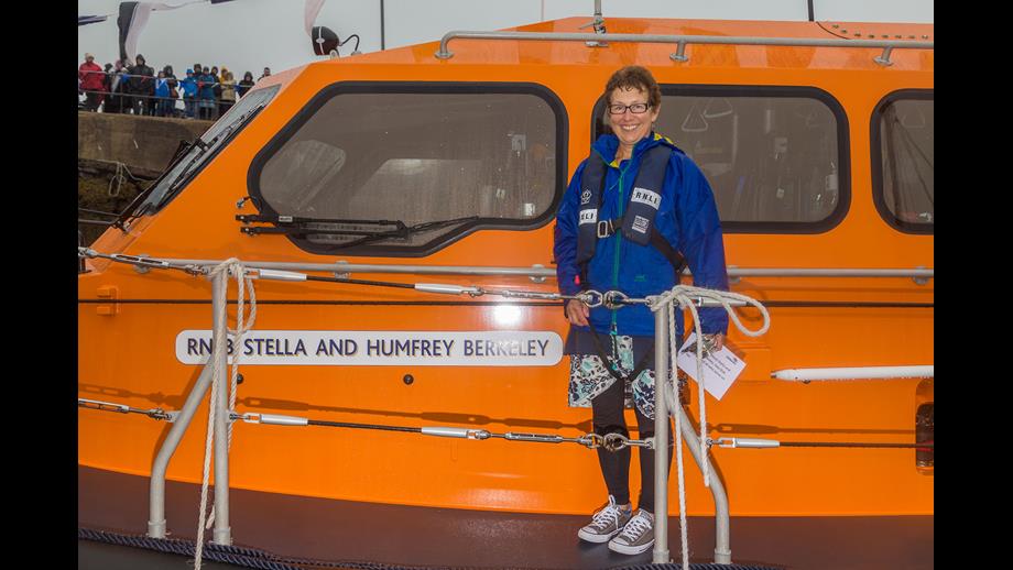 Penny Innes stands beside the name board on board the Lifeboat 