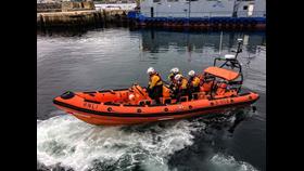 Orange lifeboat B 804 with four crew on board