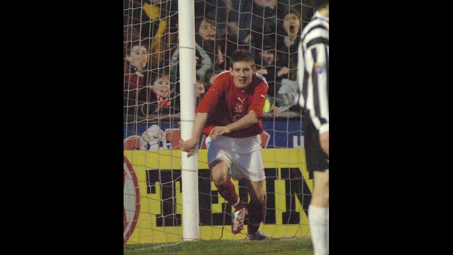 Graeme Watt in a red football top and white shorts running from the goal mouth after he scored the winning goal against Elgin City in the Scottish Cup