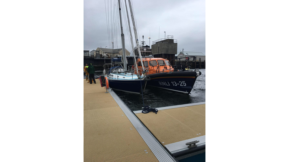 The 12m yacht, which had the injured female on board, safely alongside in Lochmaddy, with Leverburgh Lifeboat beside her.