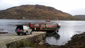 Skye Ferry aground on the pier with Mallaig lifeboat behind &amp; a Coastguard vehicle in front