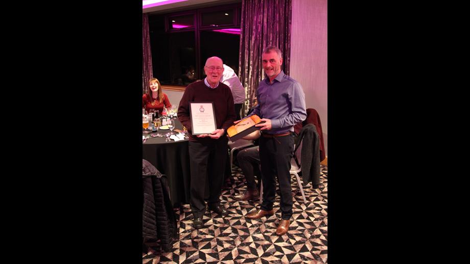 Retiring DLA John Ingram standing with his certificate with crew member David Paterson