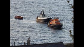 Prosperity UL 250 being towed in to Macduff Harbour by Buckie lifeboat with Macduff lifeboat astern