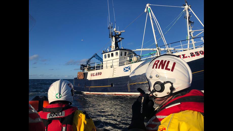 UL 250 Prosperity at sea with two lifeboat crew in the foreground