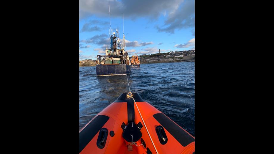 The Prosperity over the bow of Macduff lifeboat with Buckie lifeboat in view
