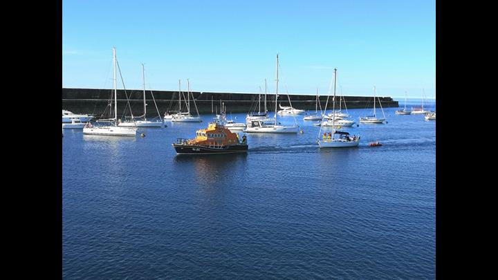 Yacht being towed to Braye Harbour