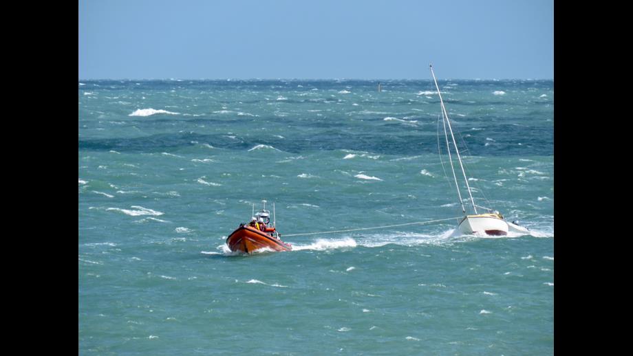 Photo of the Hayling Island RNLI Atlantic 85 lifeboat towing the yacht back into calmer waters.