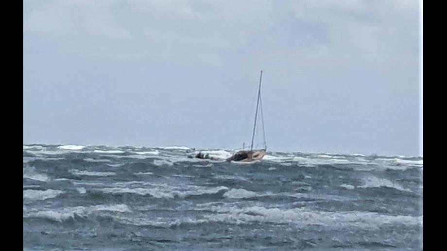 Photo of the Hayling Island Atlantic 85 lifeboat alongside the yacht in rough conditions.