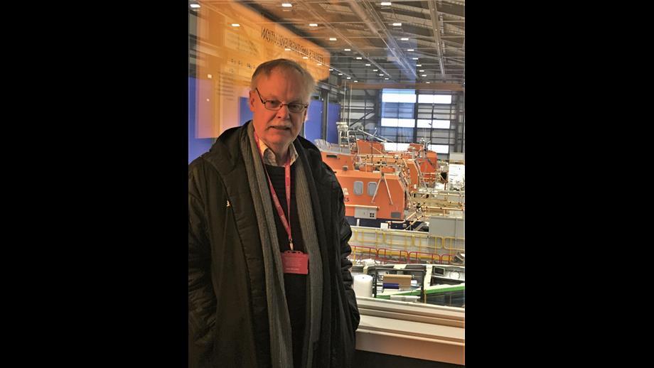 Author David with lifeboat workshops in the background