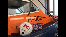 Two boxes of chocolates next to an RNLI helmet on the Hovercraft 