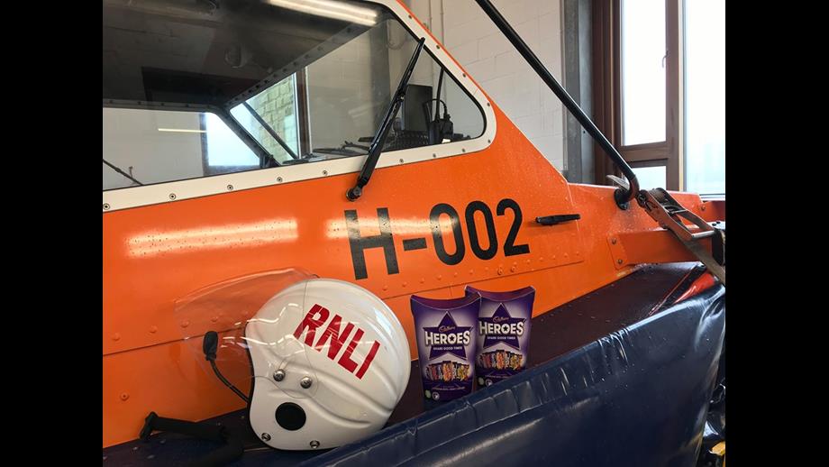 Two boxes of chocolates next to an RNLI helmet on the Hovercraft 