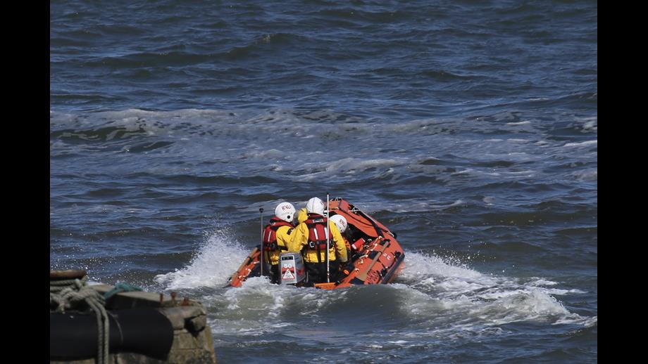 Craster lifeboat leaving the harbour to head south to the beaches yacht