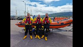 Three RNLI volunteers who saved a mans life, wearing their inshore lifeboat kit