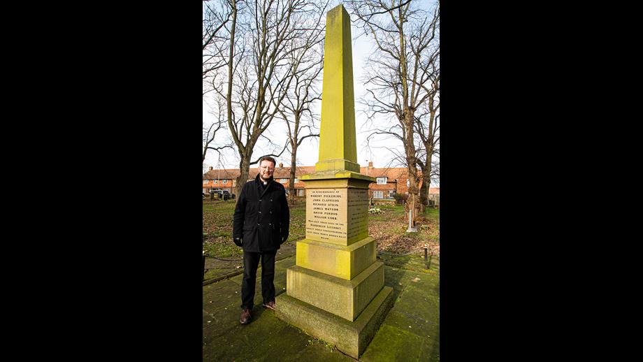 The Reverend Matthew Pollard standing next to the Great Gale Memorial