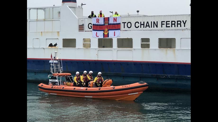Sandbanks Chain Ferry with RNLI flag and Poole lifeboat crew alongside