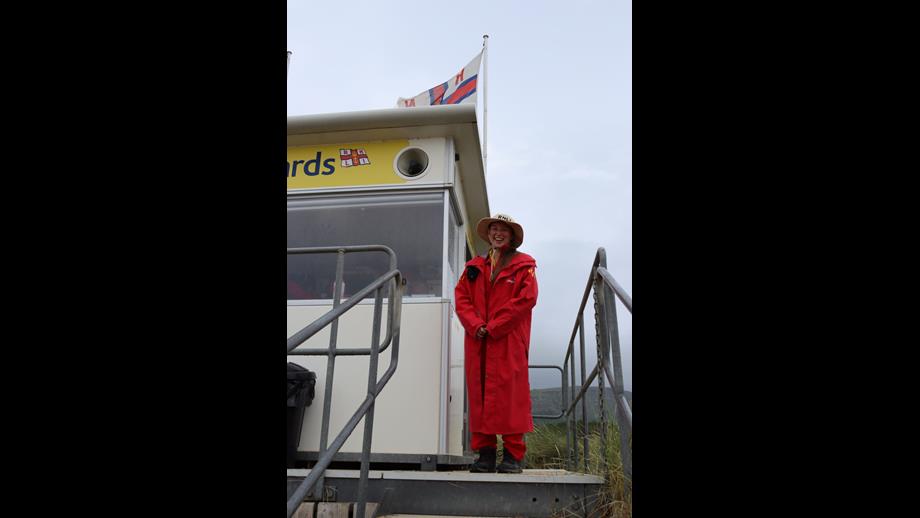RNLI Lifeguard in rain gear at the RNLI Lifeguard Beach Unit in Benone.