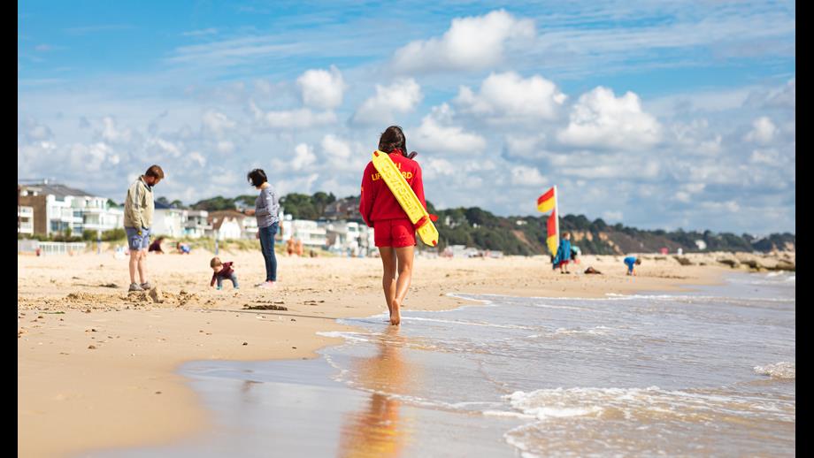 RNLI lifeguard patrolling the beach at Sandbanks in Poole