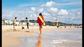 RNLI lifeguard patrolling the beach at Sandbanks in Poole