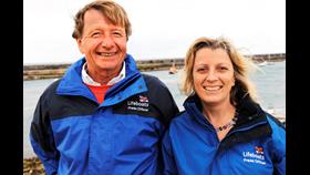 a man and a woman on the beach smiling 