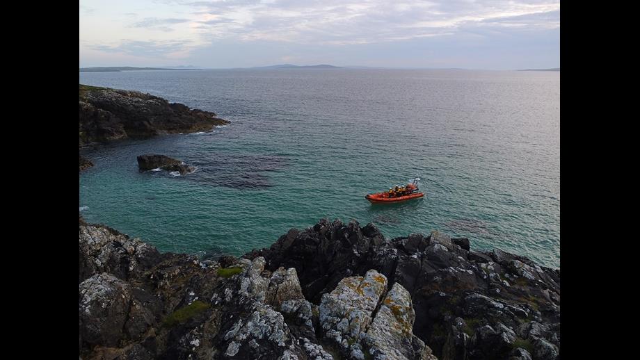 Atlantic 85 lifeboat at sea, close to rocky shore