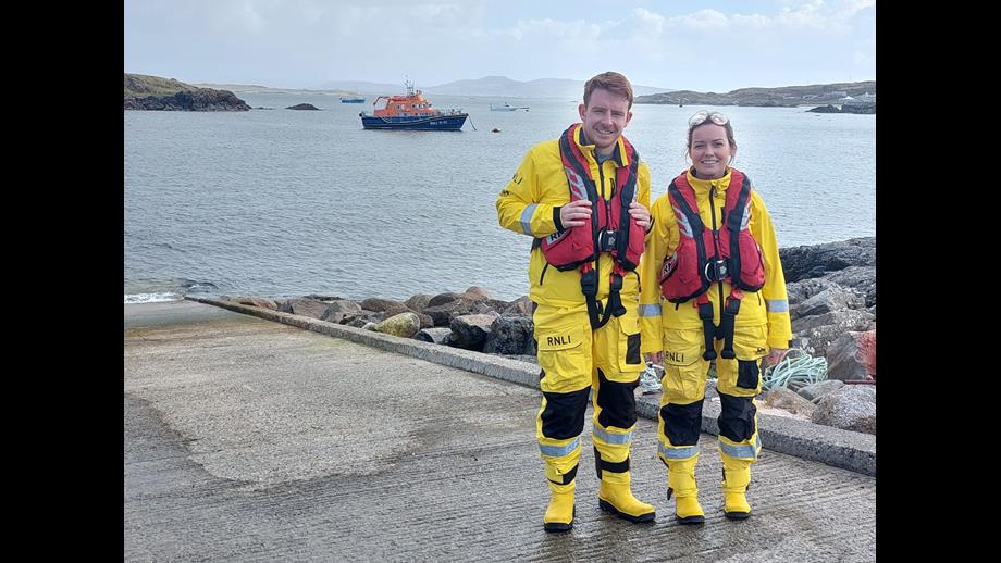 Brian Proctor and Aisling Cox of Arranmore RNLI standing at the pier with their all weather lifeboat in the background.