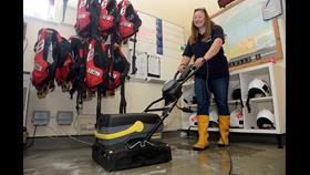 Helm Ruth Oliver swaps driving the lifeboat for the Karcher walk-behind Scrubber Dryer floor cleaner. Picture:RNLI Whitstable.
