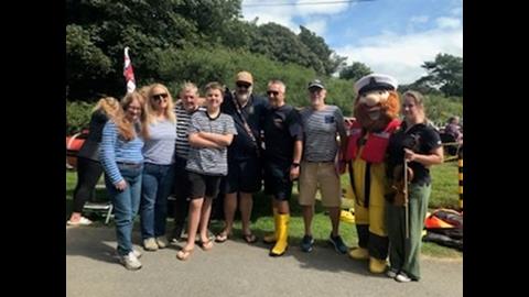 Members of the Bay Buccaneers with Steve Davies (Chair of the lifeboat station) of the Station and RNLI Mascot Stormey Sam (Claire Payne (Chair of the fundraising committee).