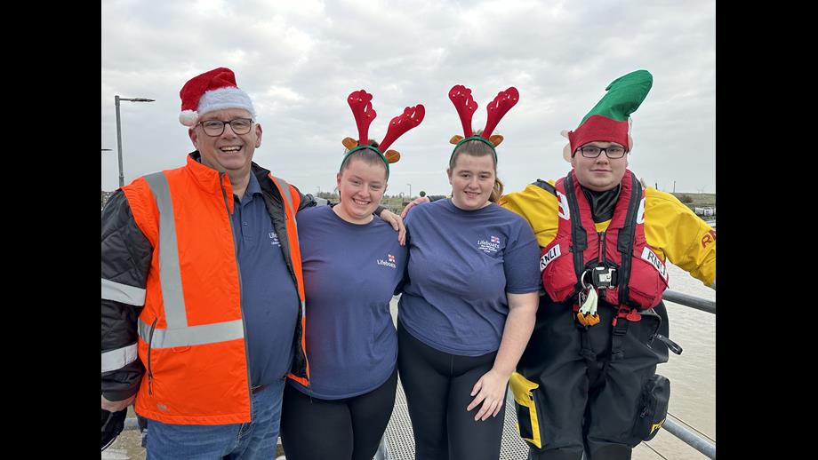Four people wearing festive headwear