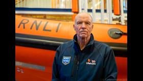 Photo of Pat Abram in front of a Lifeboat at Blackpool