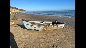 Picture of the open 12 foot dinghy ashore in Whitecliff Bay