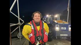 Matthew Emmerson standing infant of Flamborough lifeboat launch and recovery tractor.