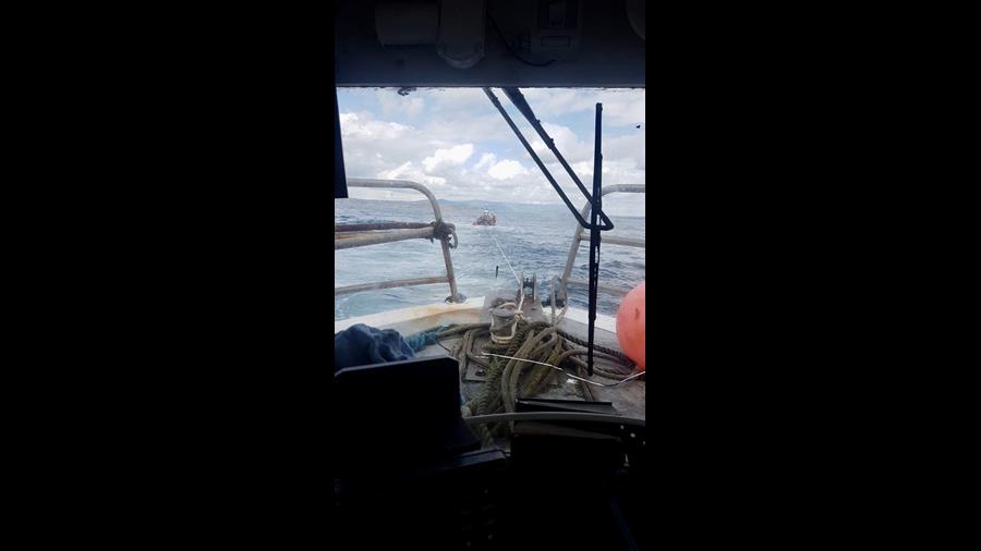 View from broken down fishing boat which is being towed by Helvick head lifeboat