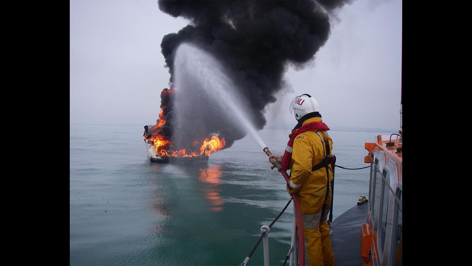 Simon Tugwell fighting a fire on board a boat from the Shoreham all weather lifeboat
