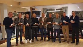 Picture of 9 of the original Stonehaven RNLI volunteer crew after having been presented with their 10 year service commemorative coins