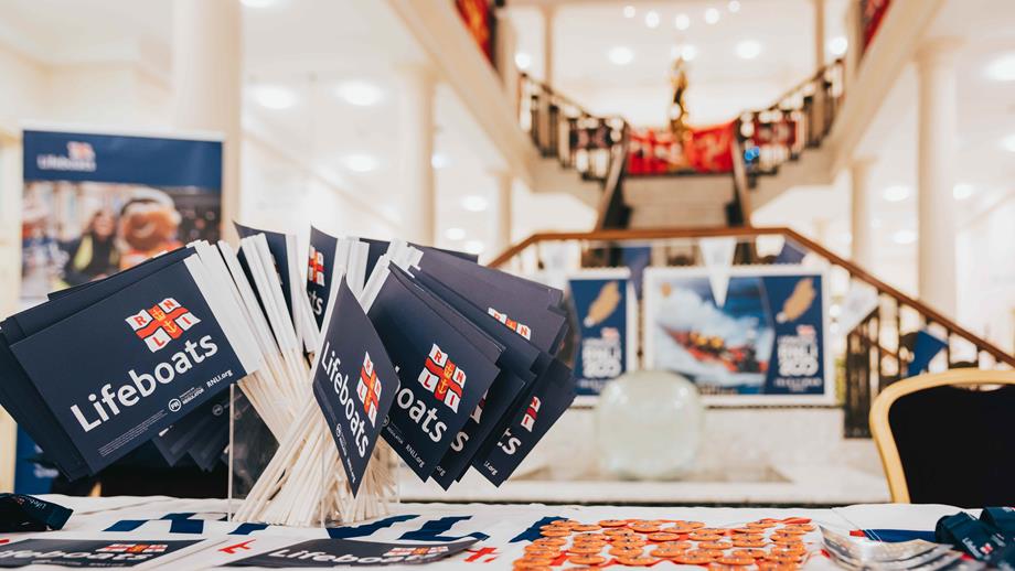 RNLI flags and leaflets on a table. 