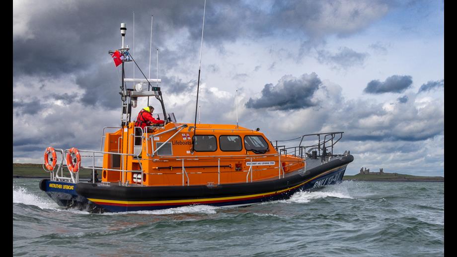 Lifeboat 13-47 passing Craster harbour, being escorted by Craster Lifeboat D838
