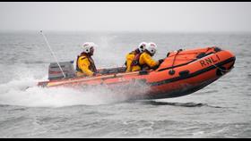 inshore lifeboat moving through water.