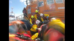 RNLI crews from Littlehampton and Shoreham assist one of the casualties from the sunken vessel.