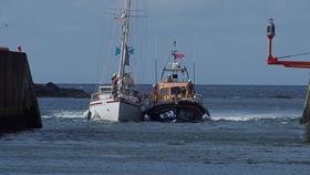 Eyemouth RNLI volunteers tow casualty yacht into Eyemouth harbour after the yacht had engine failure at the Hurkar rocks.
