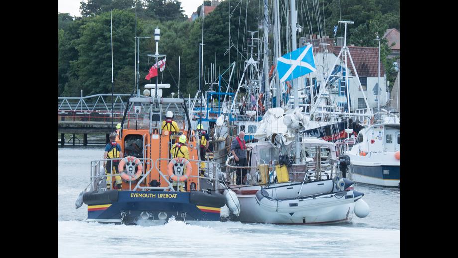 Eyemouth RNLI volunteers tow casualty yacht into Eyemouth harbour after the yacht had engine failure at the Hurkar rocks