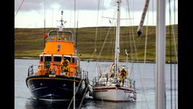 RNLI Lerwick Lifeboat brings the 12-metre yacht into the Albert Dock in Lerwick Harbour.
