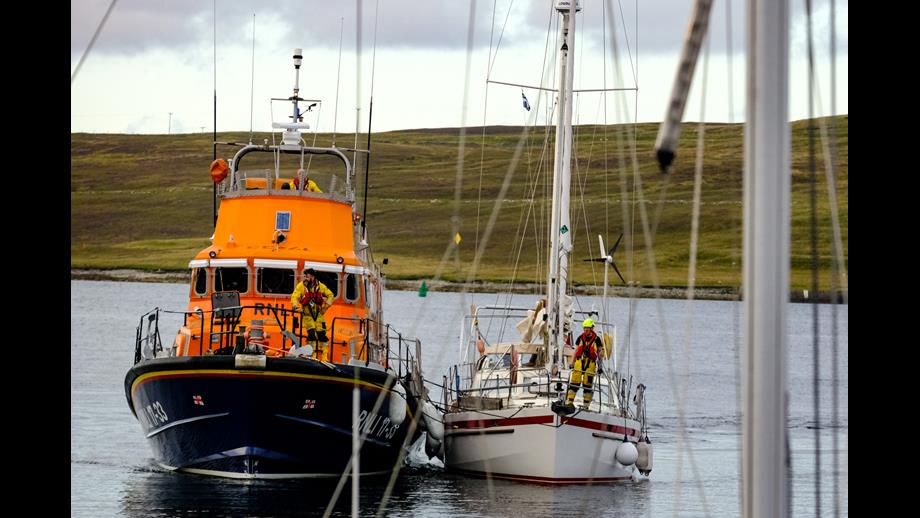 RNLI Lerwick Lifeboat brings the 12-metre yacht into the Albert Dock in Lerwick Harbour.
