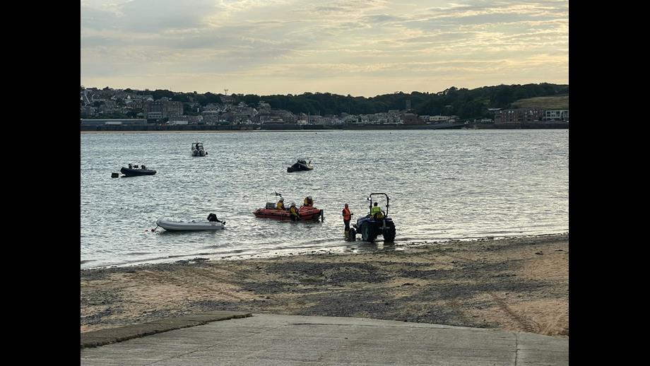 As the sun sets behind Padstow, Rock volunteer lifeboat crew launch into the Camel Estuary.