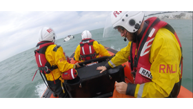 Lifeboat approaches stricken yacht.