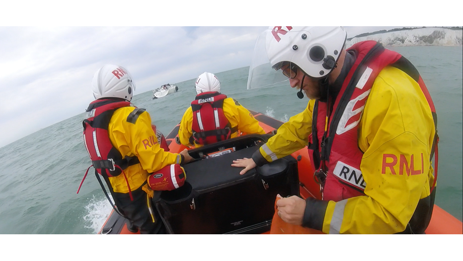 Lifeboat approaches stricken yacht.