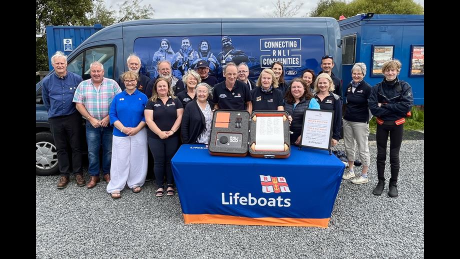 Volunteers from Lough Derg RNLI standing with the RNLI scroll at the centre 