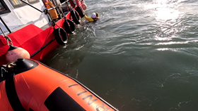 Skerries RNLI Volunteer in the water with the casualty