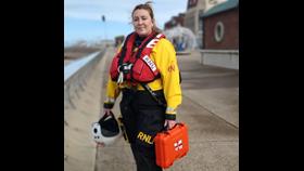 Female RNLI crew member holding time capsule case