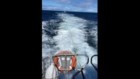 Eyemouth RNLI lifeboat tows fishing boat, the casualty vessel can be see behind the all-weather lifeboat.